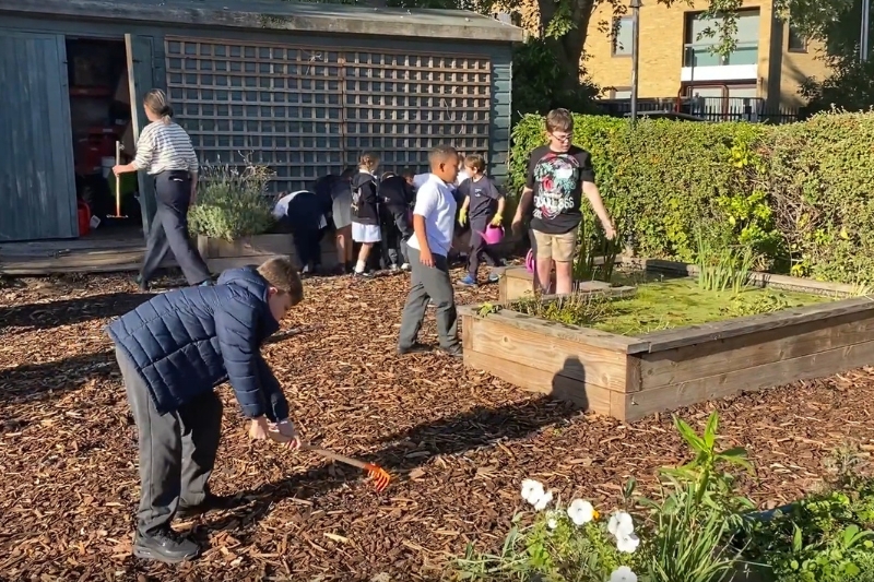 School pupils tend to a garden at Sacred Heart RC Primary School in Battersea