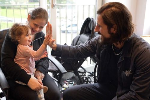 Councillor Aydin Dikerdem gets a high-five from April's daughter
