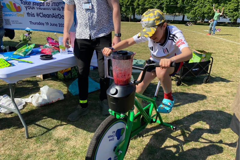 Girl pedals smoothie making bicycle