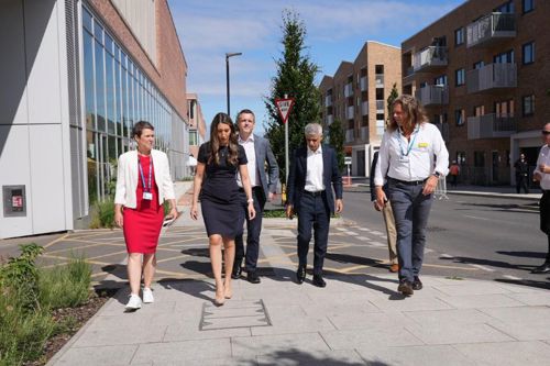 A group of people walking through the newly developed Springfield Village